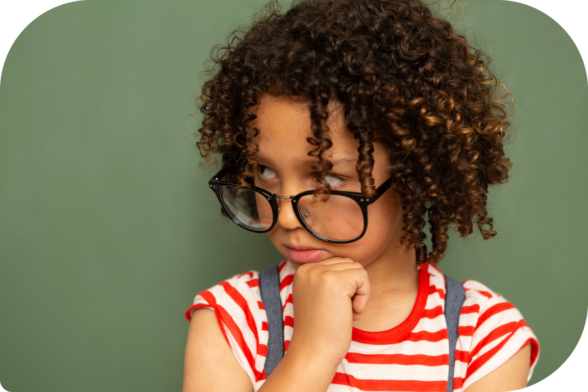 thoughtful-schoolgirl-standing-against-a-green-boa-2021-08-28-16-45-30-utc